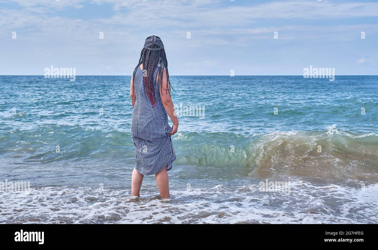 Long black hair blue dress hi-res stock photography and images - Alamy