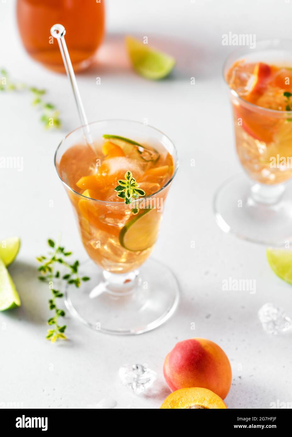 Homemade fresh apricot cocktail with ice, lime and lemon thyme