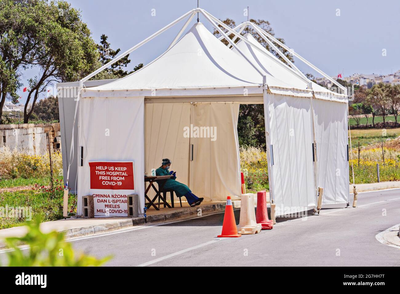 Nurse sits in temporary pavilion for control coronavirus at entrance to