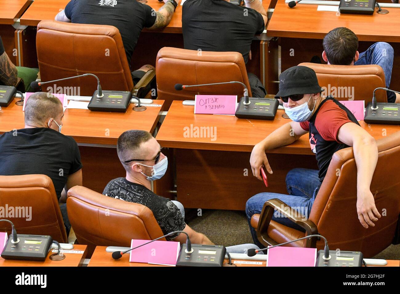 ZAPORIZHZHIA, UKRAINE - JULY 14, 2021 - Unidentified young men occupy the  session hall of the Zaporizhzhia City Council as a meeting was about to  begi Stock Photo - Alamy