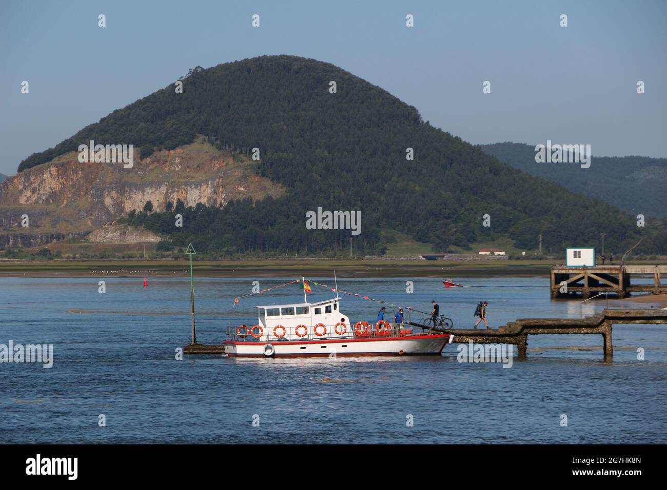 The Santona - Laredo ferry at the jetty in Santona Cantabria Spain on a sunny June morning with few passengers Stock Photo