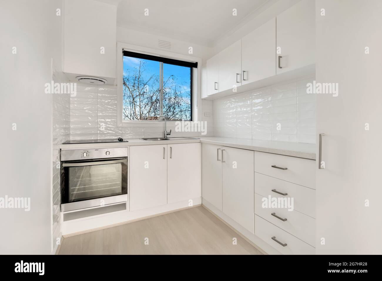 Kitchen interior design. White furniture and wooden floor Stock Photo