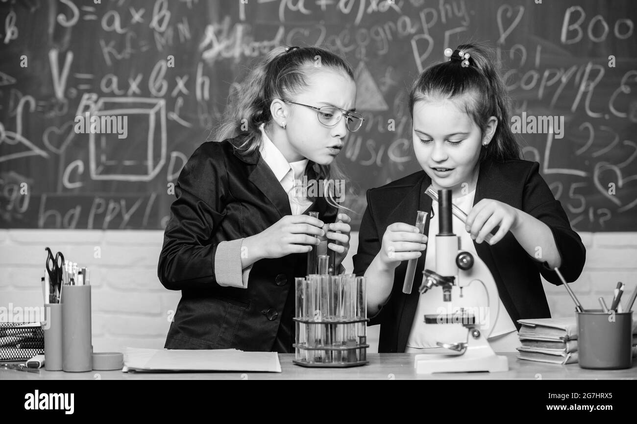 Biology lab. Happy Genius. Little girls scientist with microscope