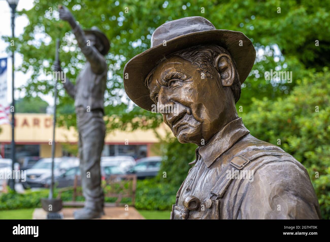 Statues of The Potter (front) and The Discovery (back), depicting a gold miner, at the historic Courthouse Square in downtown Cleveland, GA. (USA) Stock Photo