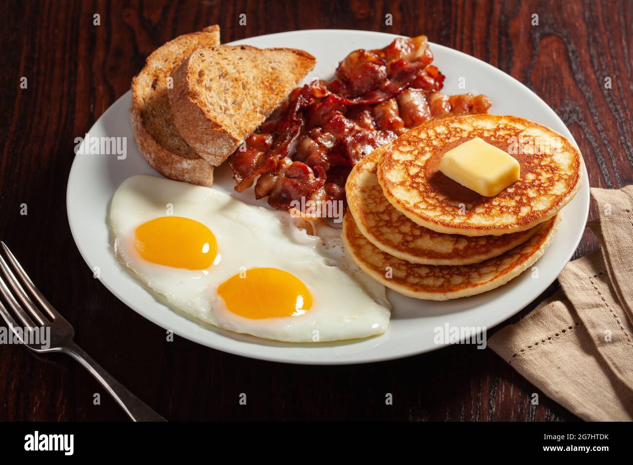 traditional full american breakfast eggs pancakes with bacon and toast Stock Photo