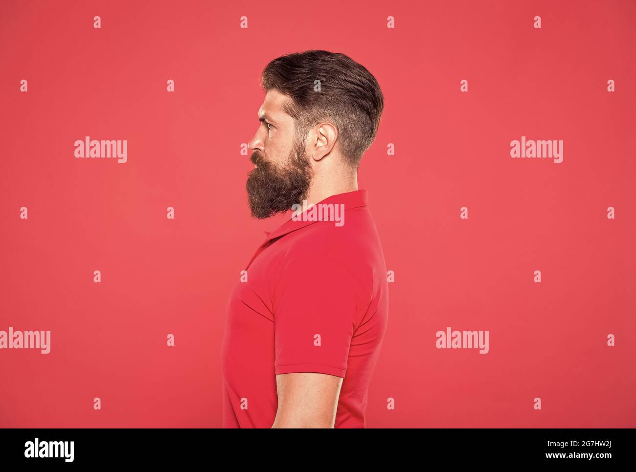 Confident in his attractiveness. Bearded and cool. Hipster appearance. Beard fashion. Barber concept. Man bearded hipster red background. Barber tips Stock Photo