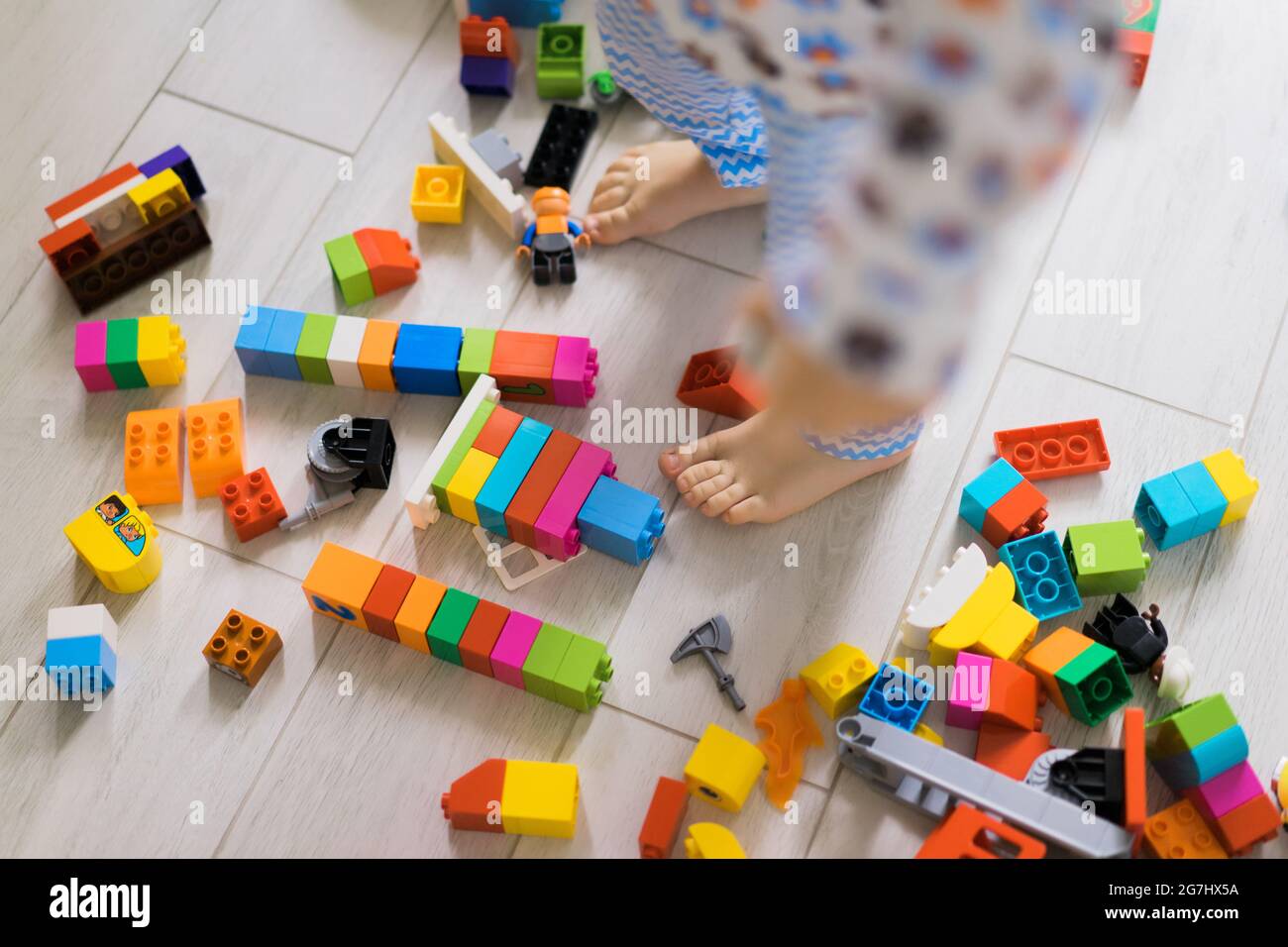 boy child playing with his mother in color children's building kit. The