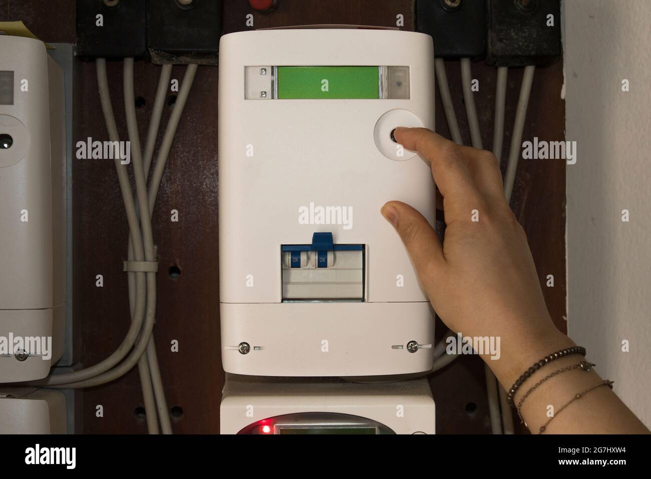 Woman checks energy consumption on a electricity meter Stock Photo Alamy