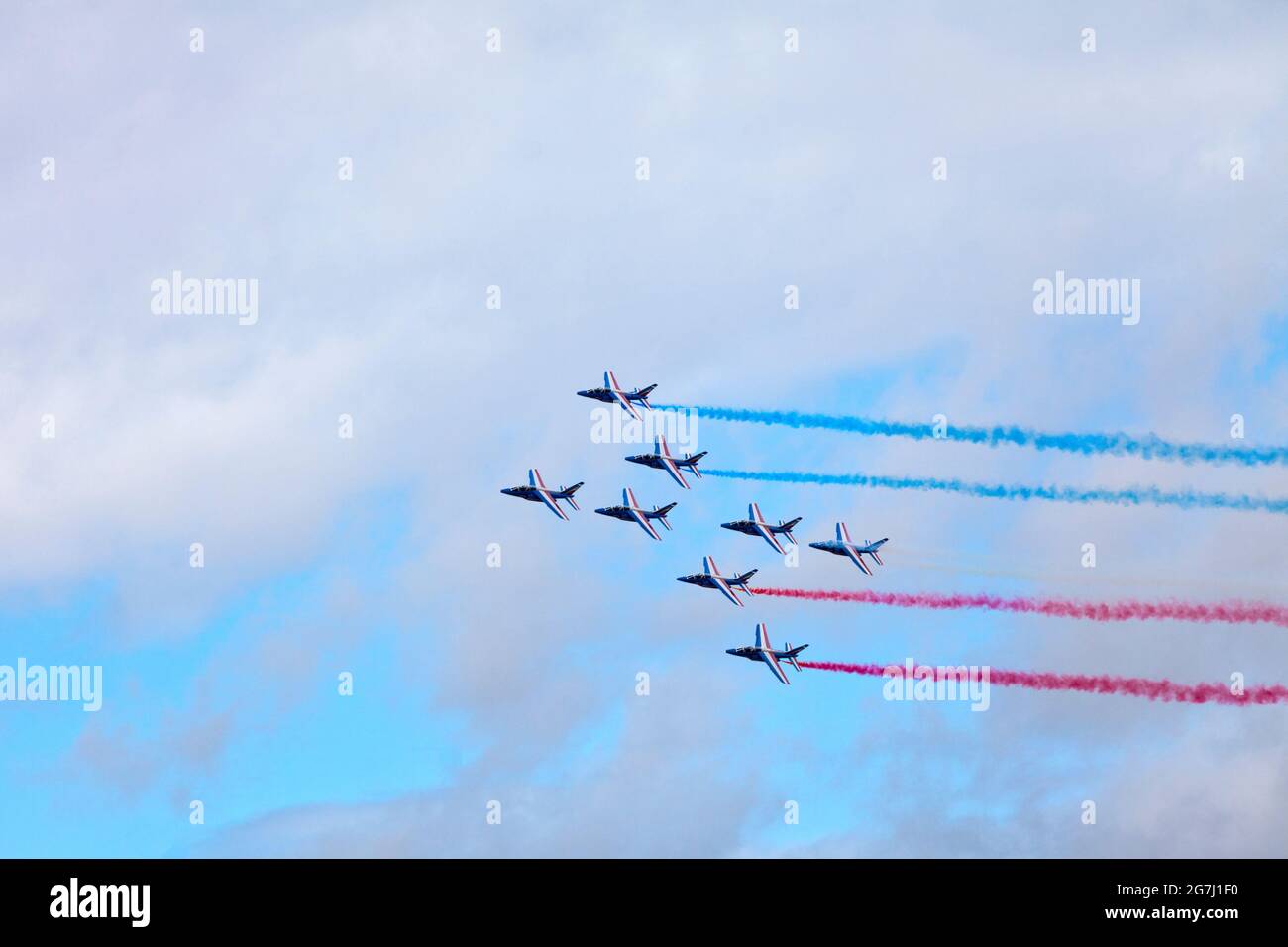 Paris, France - July 14 2021: The French Air Patrol (French: Patrouille de France) performing a demonstration to celebrate the Bastille Day. Stock Photo