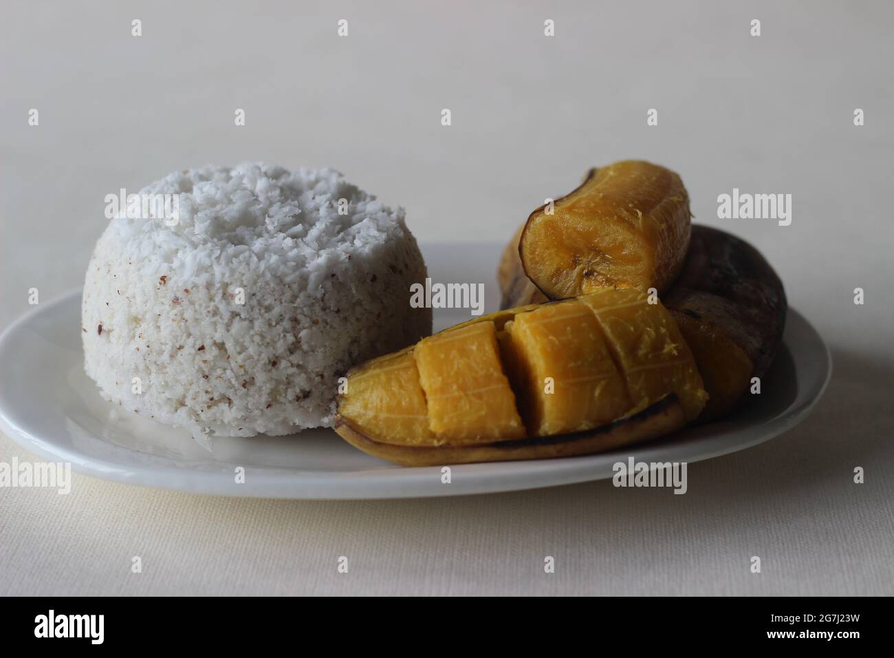 Steamed rice cake served with steamed plantain. A favorite breakfast