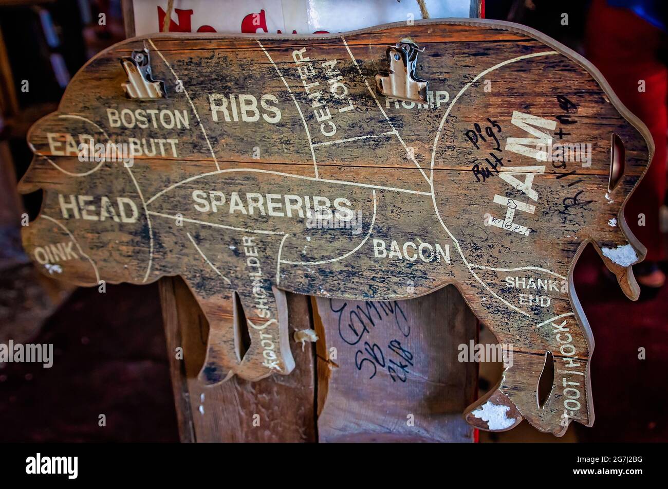 A wooden pig diagram shows the cuts of pork in relation to the animal body parts at The Shed Barbeque and Blues Joint, July 4, 2021, in Ocean Springs, Stock Photo