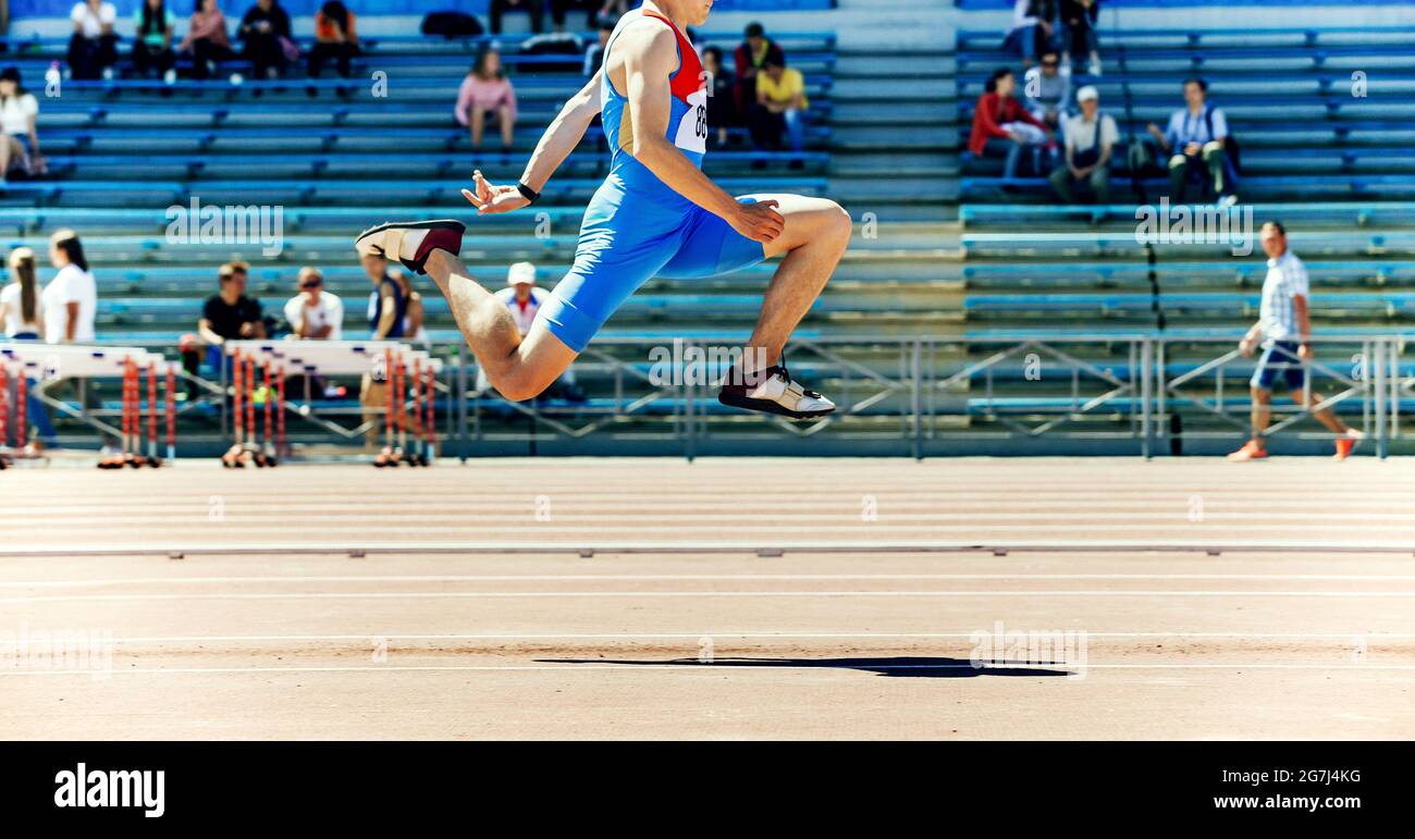 male athlete triple jump track and field competition Stock Photo