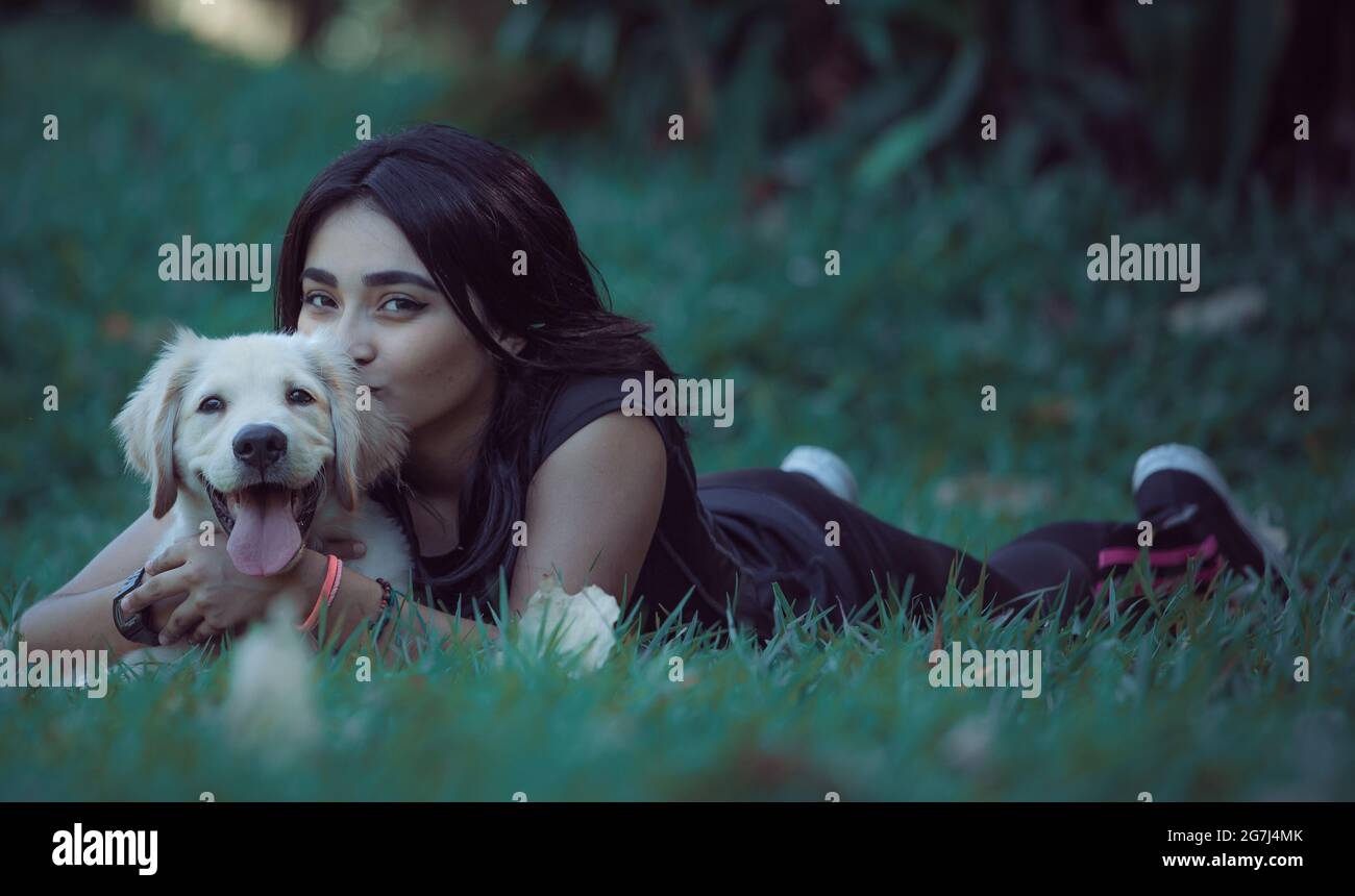 Young girl posing outdoors with her friendly dog Stock Photo - Alamy
