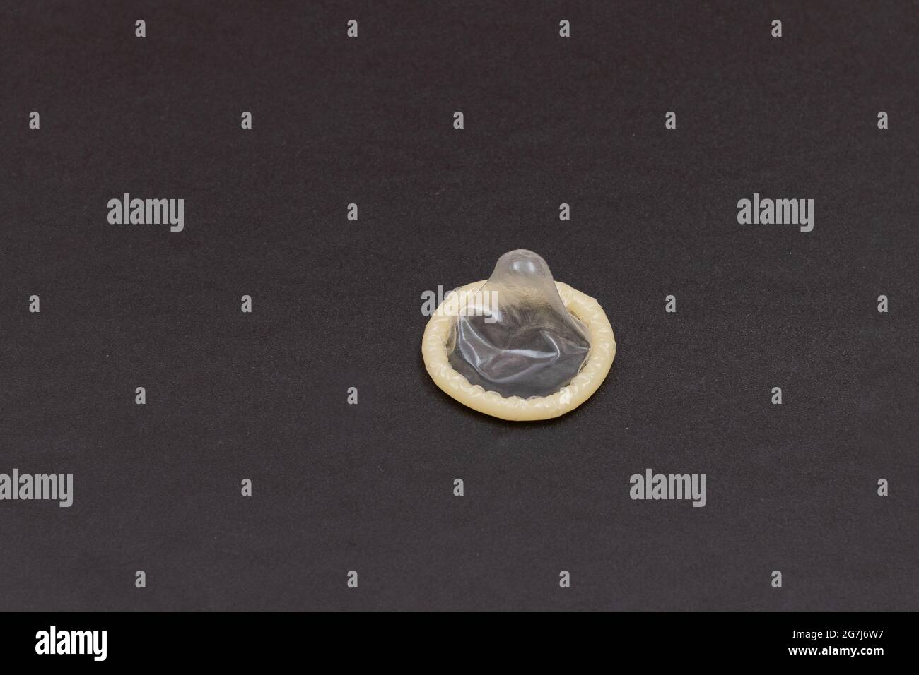 Unpacked Latex Condom On Black Background Stock Photo