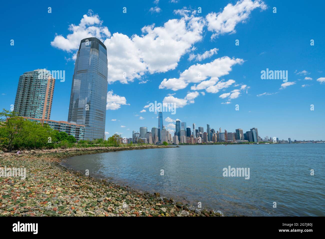High-rise buildings stand beside the beach at Hudson River in New Jersey ward. Stock Photo