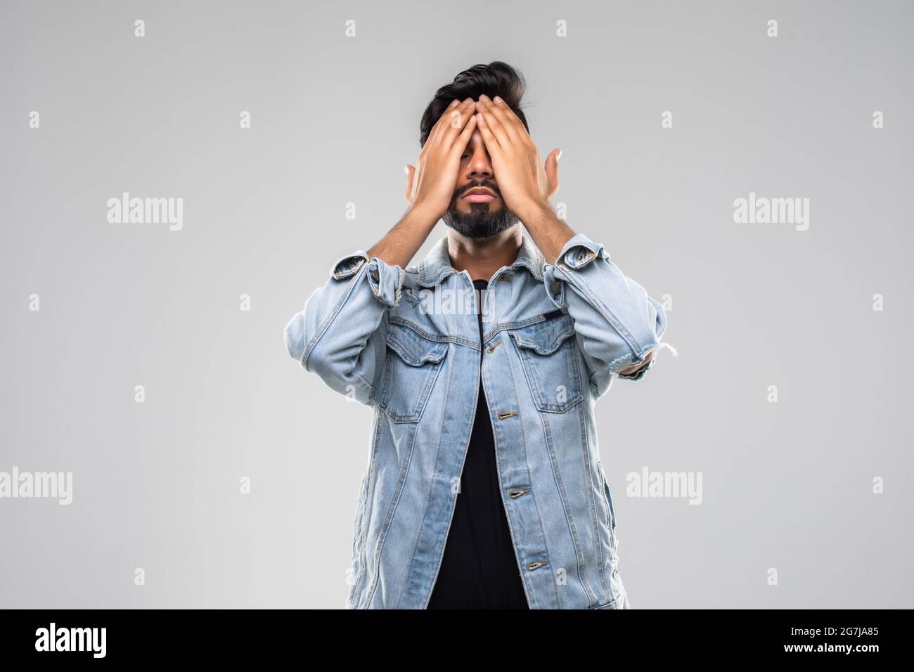 Portrait Of An Businessman Covering Eyes Isolated On Grey Background Stock Photo