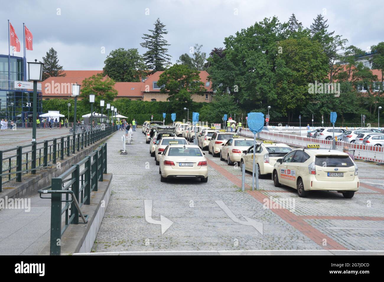 Taxis parked waiting to pick passengers outside the vaccination centre of the Berlin fairgrounds - Berlin, Germany - July 14, 2021. Stock Photo