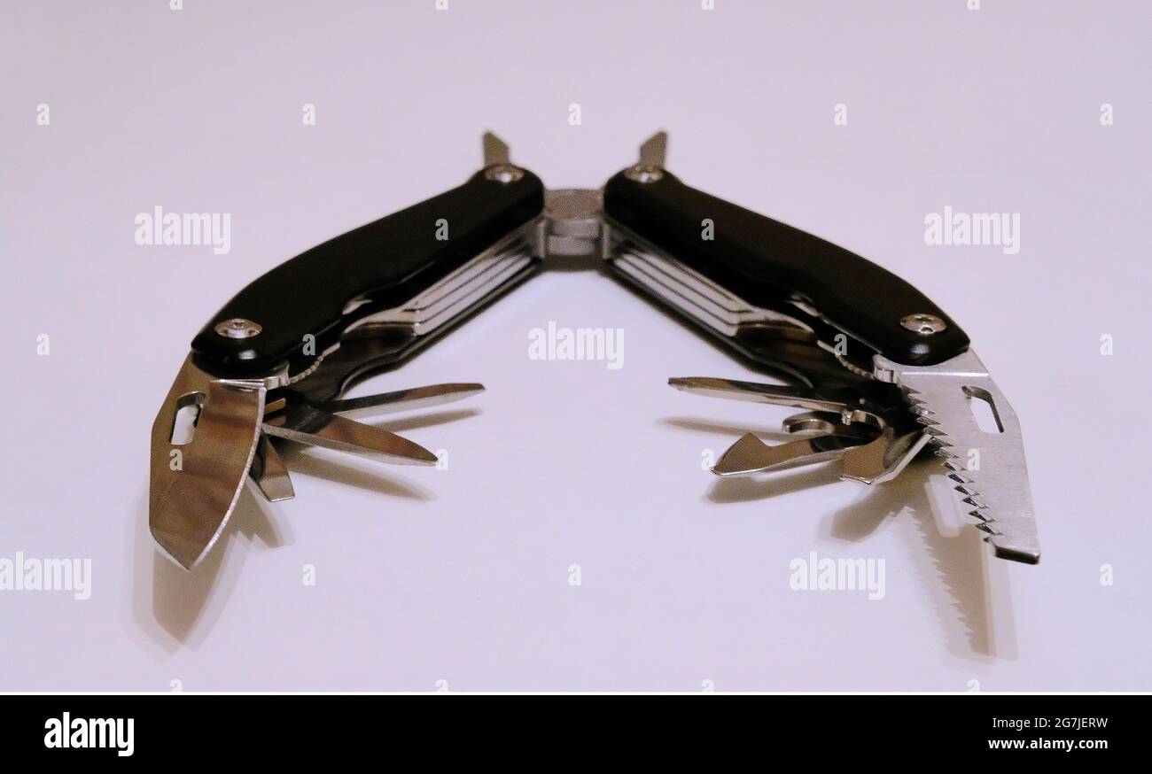 Black multitool on a white background Stock Photo