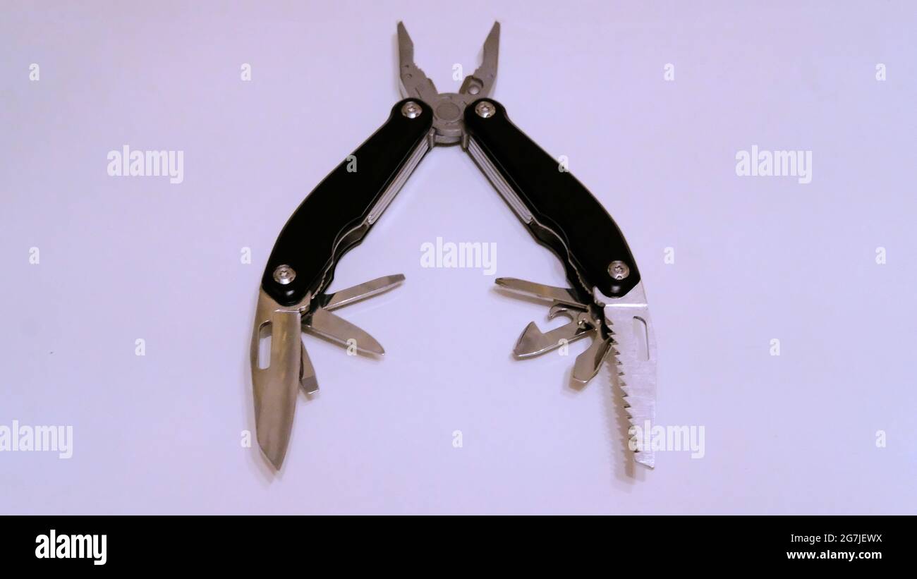 Folded black multitool on a white background Stock Photo
