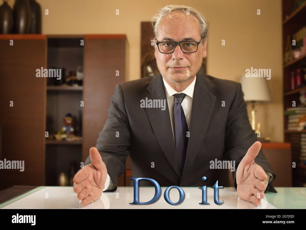 businessman with open arms looking confidently in front over the text do it Stock Photo