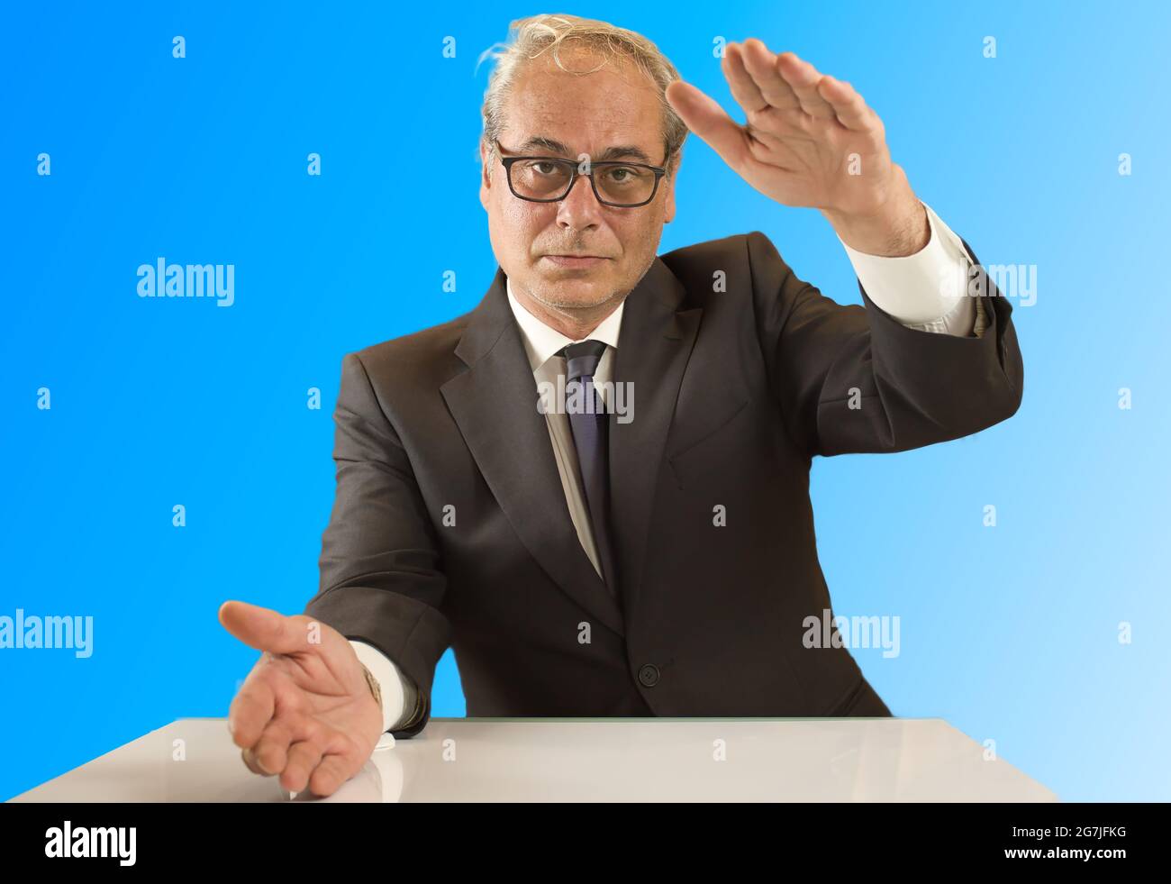 businessman with open arms looking confidently in front with blue background Stock Photo