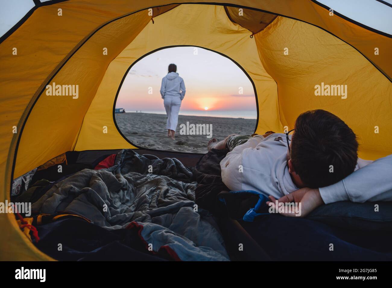 couple sleeping in camping tent looking at sunrise. hiking concept. sea  beach Stock Photo - Alamy