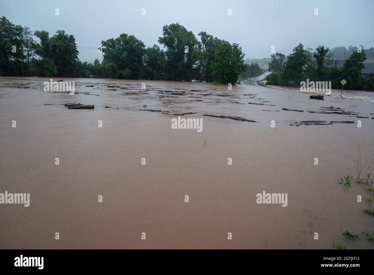 Nattenheim, Germany. 14th July, 2021. County road 74 between Rittersdorf and Nattenheim is flooded by the Nims. Continuous rainfall has flooded numerous villages and cellars in Rhineland-Palatinate. Credit: Harald Tittel/dpa/Alamy Live News Stock Photo