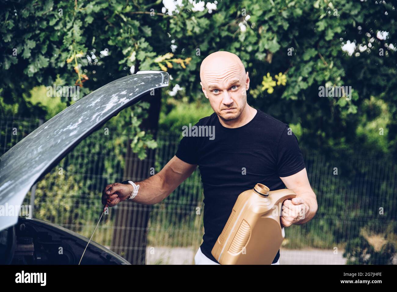 Man checks the engine oil level of the car. Car inspection before ...