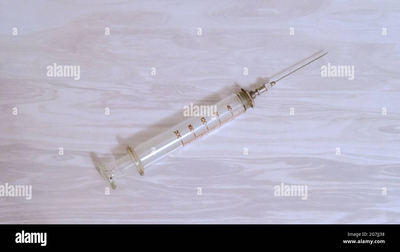 Glass syringe with a metal needle on Stock Photo