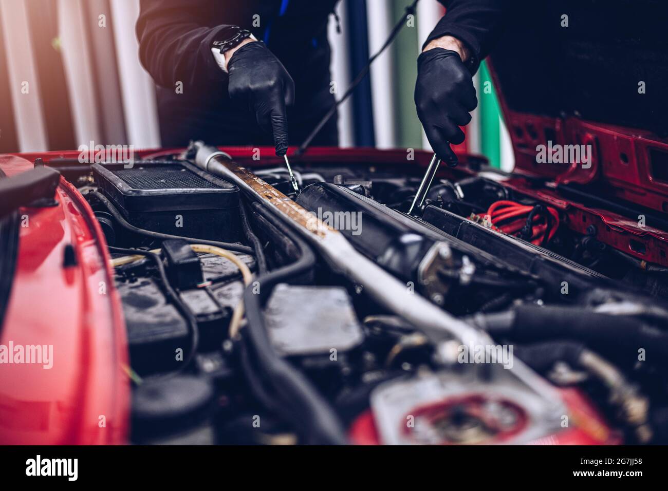 Car mechanic repairing customer engine with wrench Stock Photo - Alamy