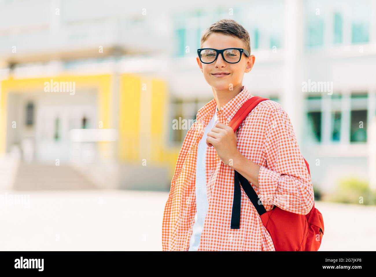 Portrait of a cute boy in glasses who is going to school with his ...