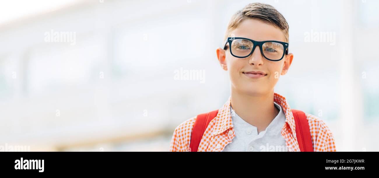 Portrait of a cute boy in glasses who is going to school with his ...