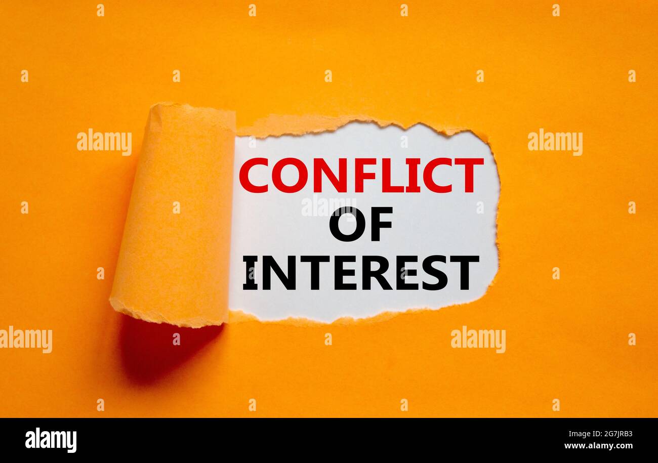 Conflict of interest symbol. Words 'Conflict of interest' appearing behind torn orange paper. Beautiful orange background. Business, conflict of inter Stock Photo