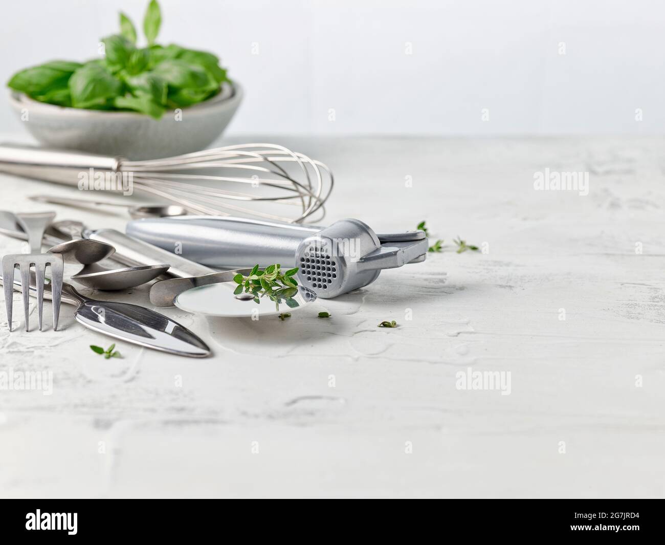 various cooking utensils on white kitchen table Stock Photo