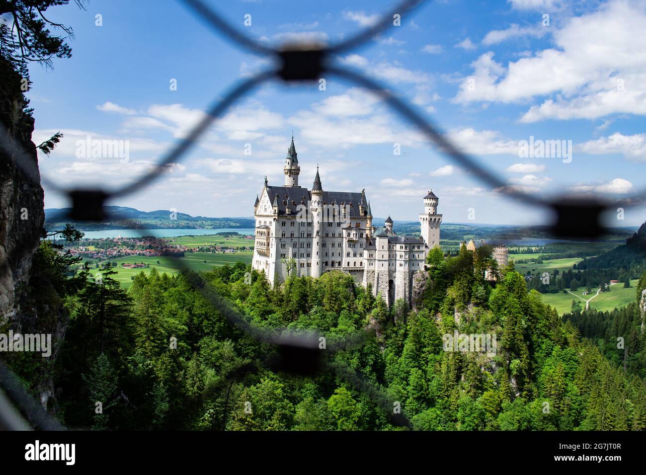 Summer at Neuschwanstein Castle seen through a viewing gate for a different perspective Stock Photo