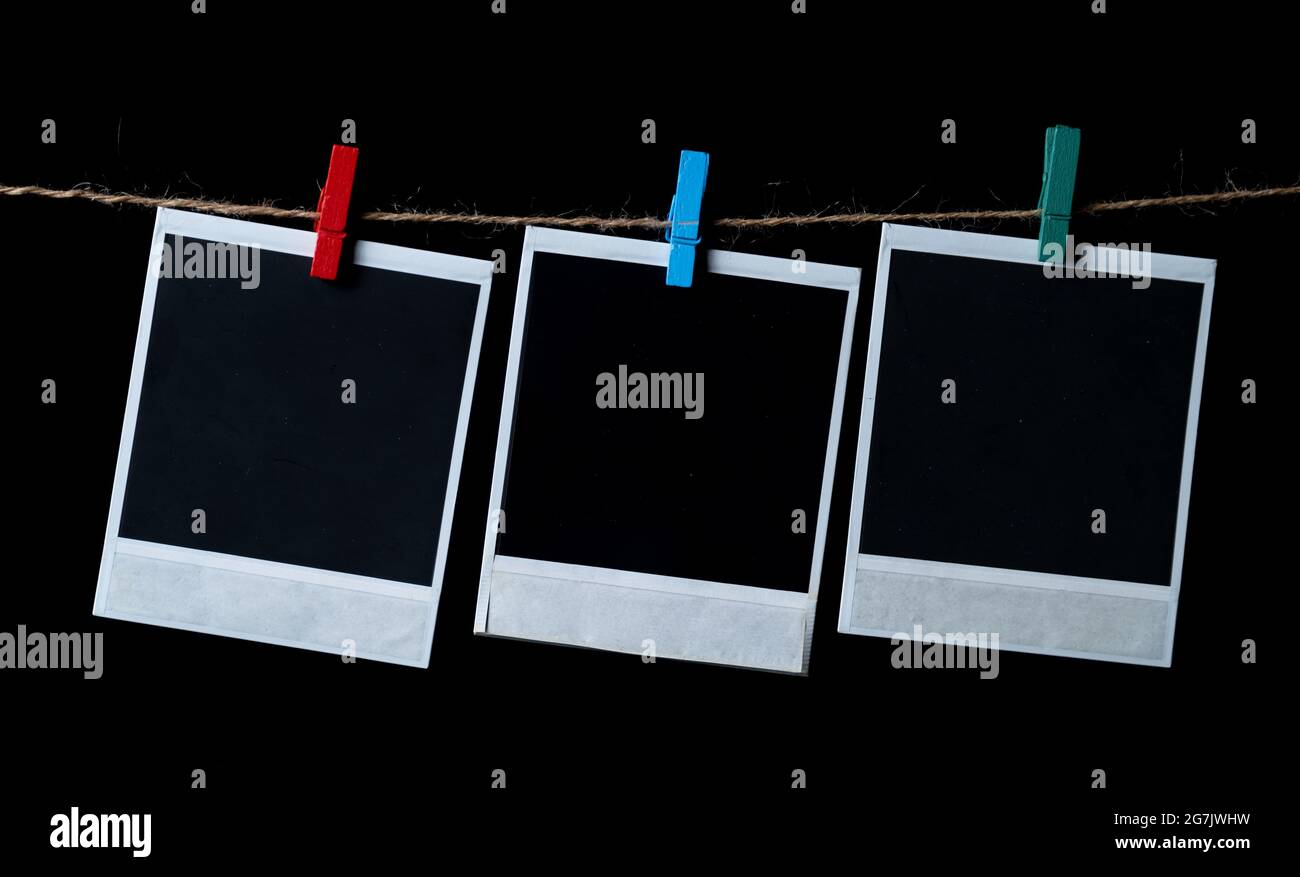 Blank square photo frames hanging on a clothesline Stock Photo