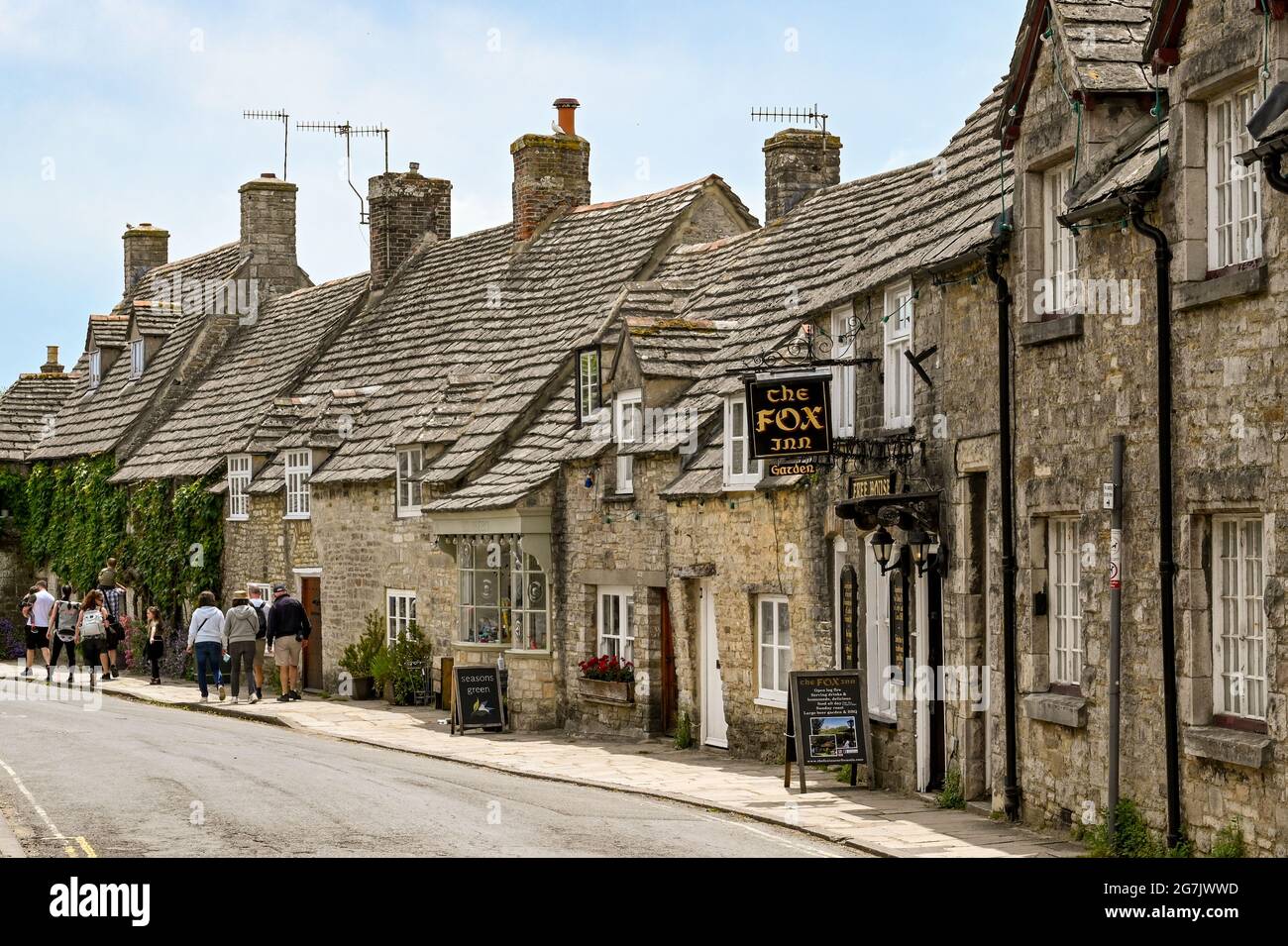 Corfe Castle, Dorset, England - June 2021: Small pub in one of the streets of old traditional houses in the village of Corfe Castle.. Stock Photo