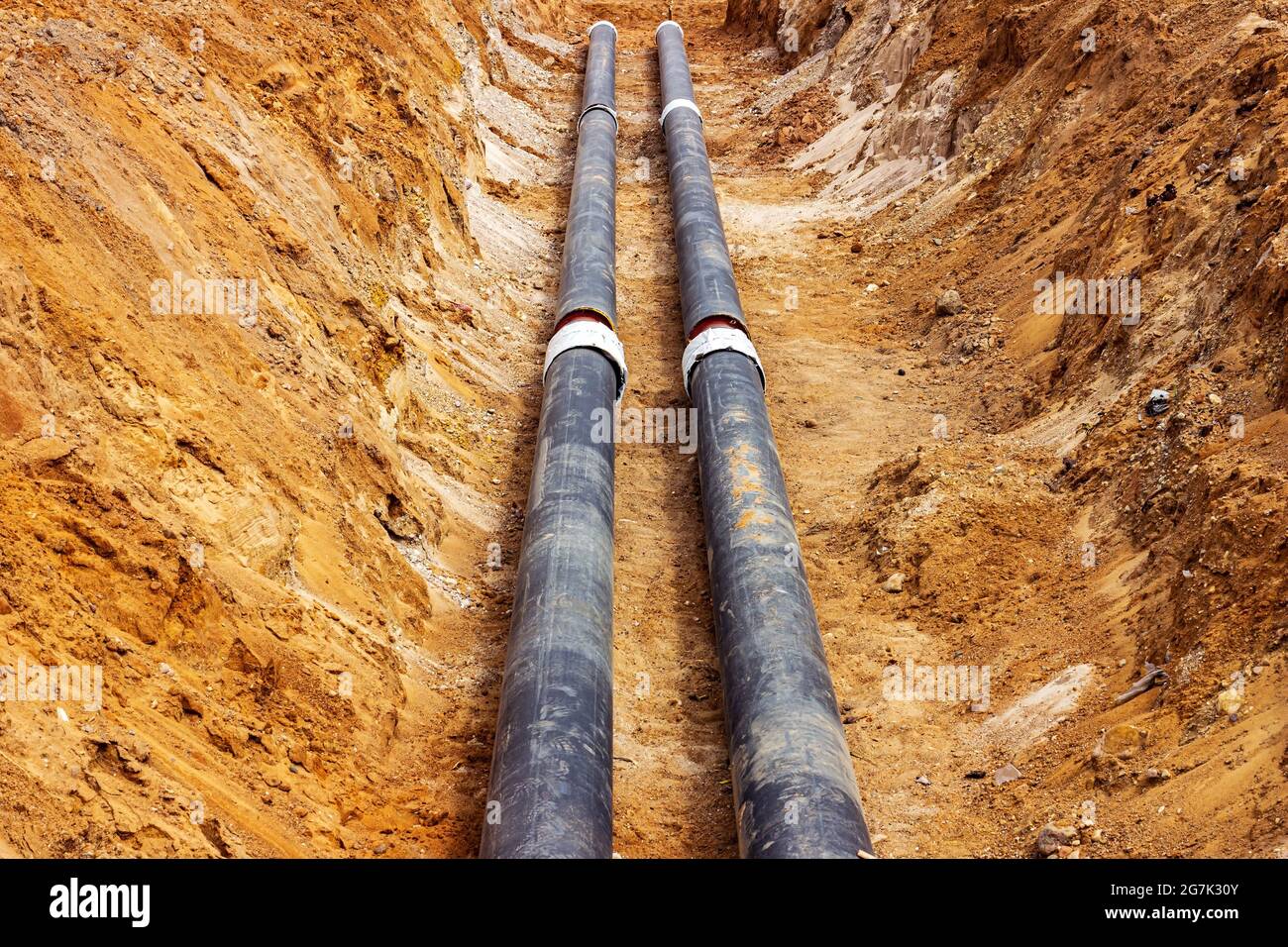 Installation of the distribution unit of heating and water supply network. Frame for connecting pipes in the trench of ground. Stock Photo