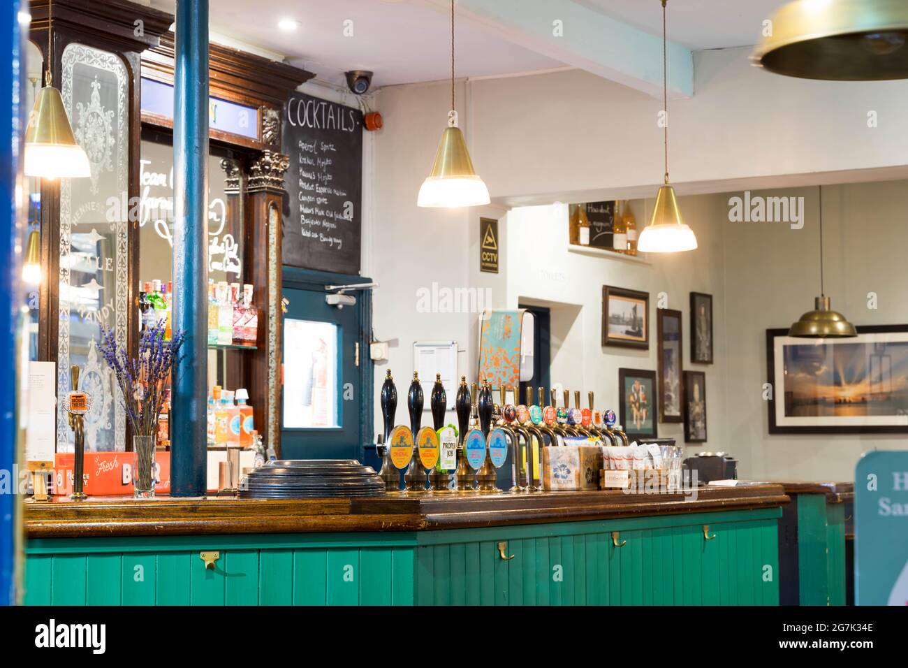 Interior of a traditional British pub showing hand beer pumps in London Greenwich England UK coaches & horses Stock Photo