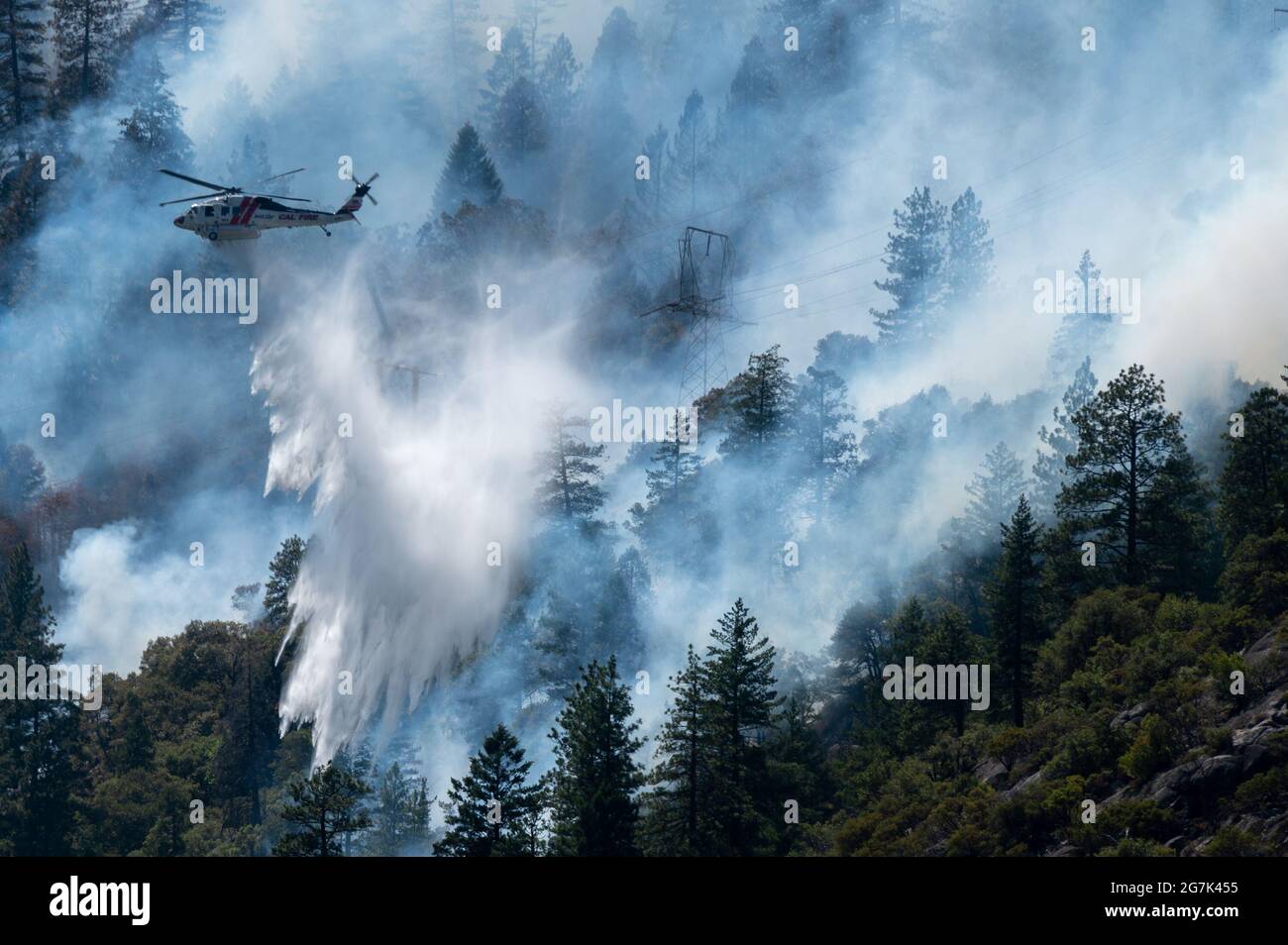 Plumas County, CA, USA. 14th July, 2021. Helicoptors drop water to battle the Dixie Fire on Highway 70 in the Feather River Canyon in Plumas County on Wednesday, July 14, 2021 in Plumas County. The fire started near the origin of 2018's deadly Camp Fire Credit: Paul Kitagaki Jr./ZUMA Wire/Alamy Live News Stock Photo