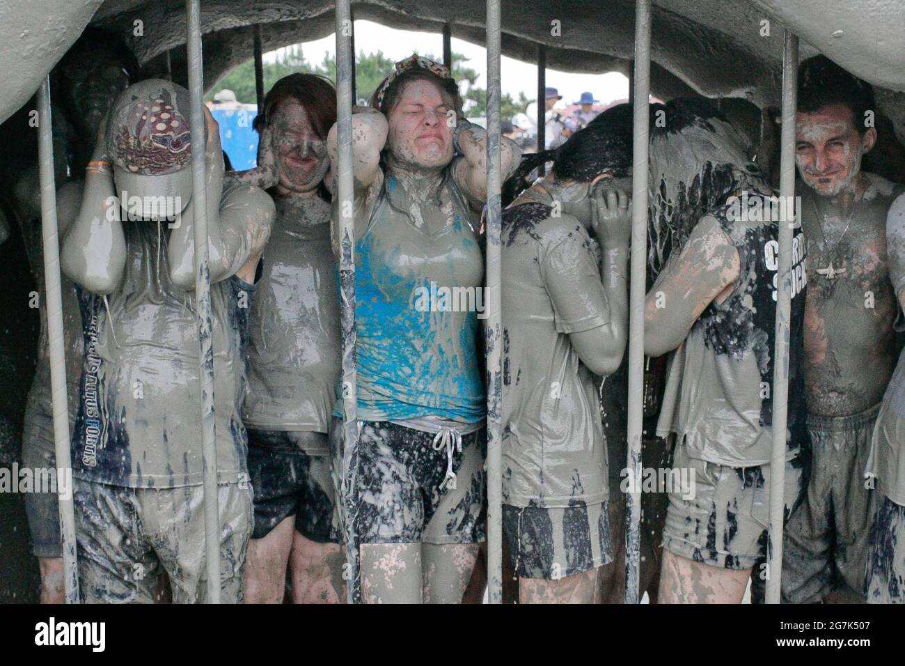 July 15, 2021-Boryeong, South Korea-A Visitors  enjoying wrestle in the mud pool during an Annual Boryeong Mud Festival at Daecheon Beach in Boryeong, South Korea. The mud, which is believed to have beneficial effects on the skin due to its mineral content, is sourced from mud flats near Boryeong and transported to the beach by truck. Stock Photo