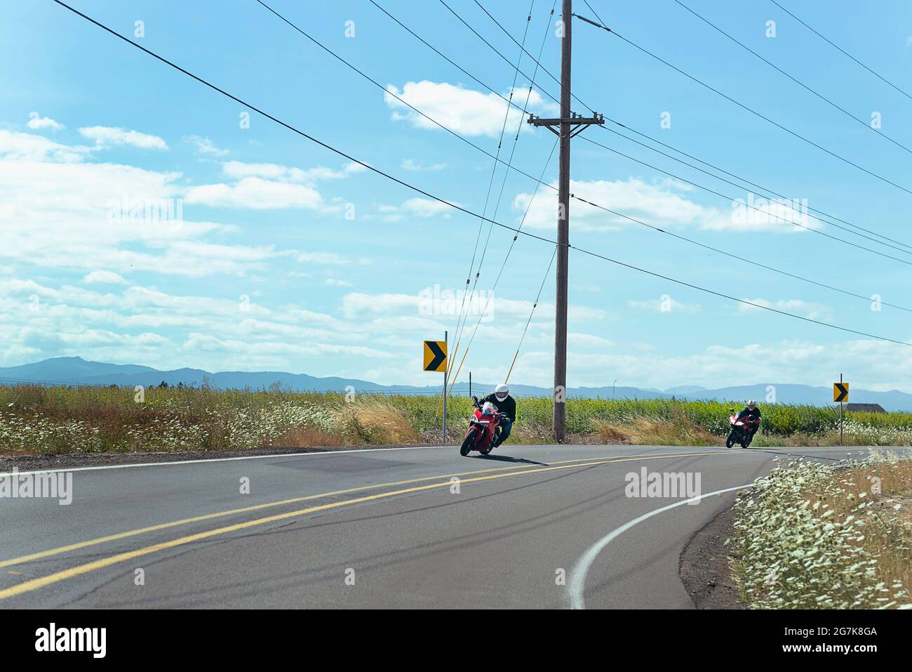 Motorcycles taking a curve on a country road. Stock Photo