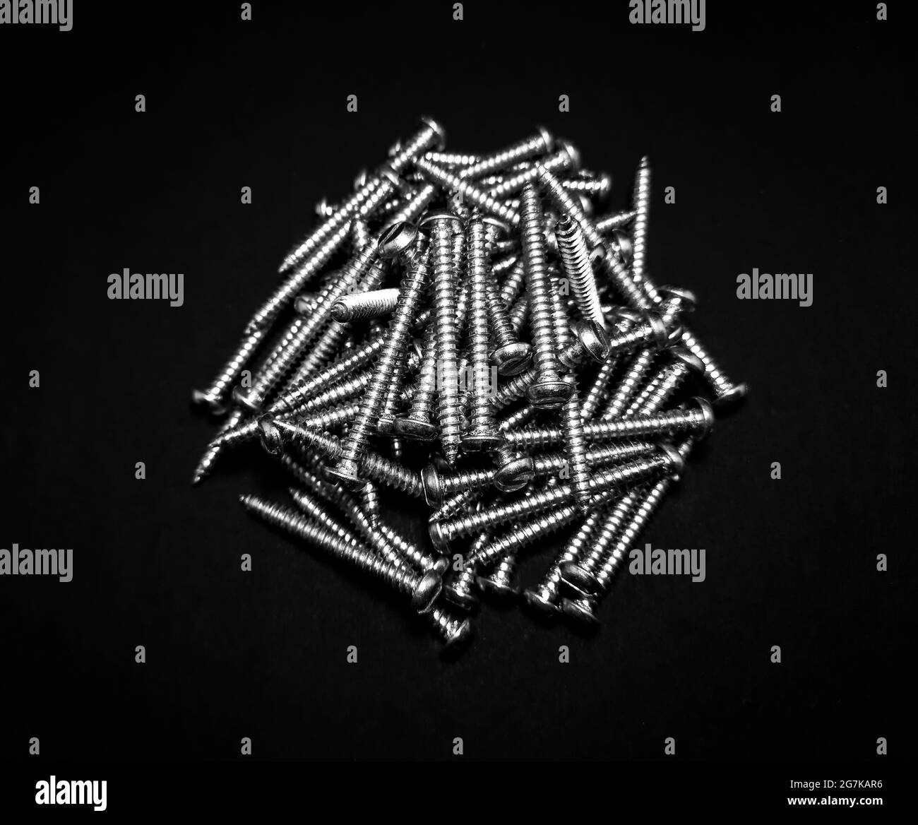 Top view of a collection of new iron nails on a black isolated