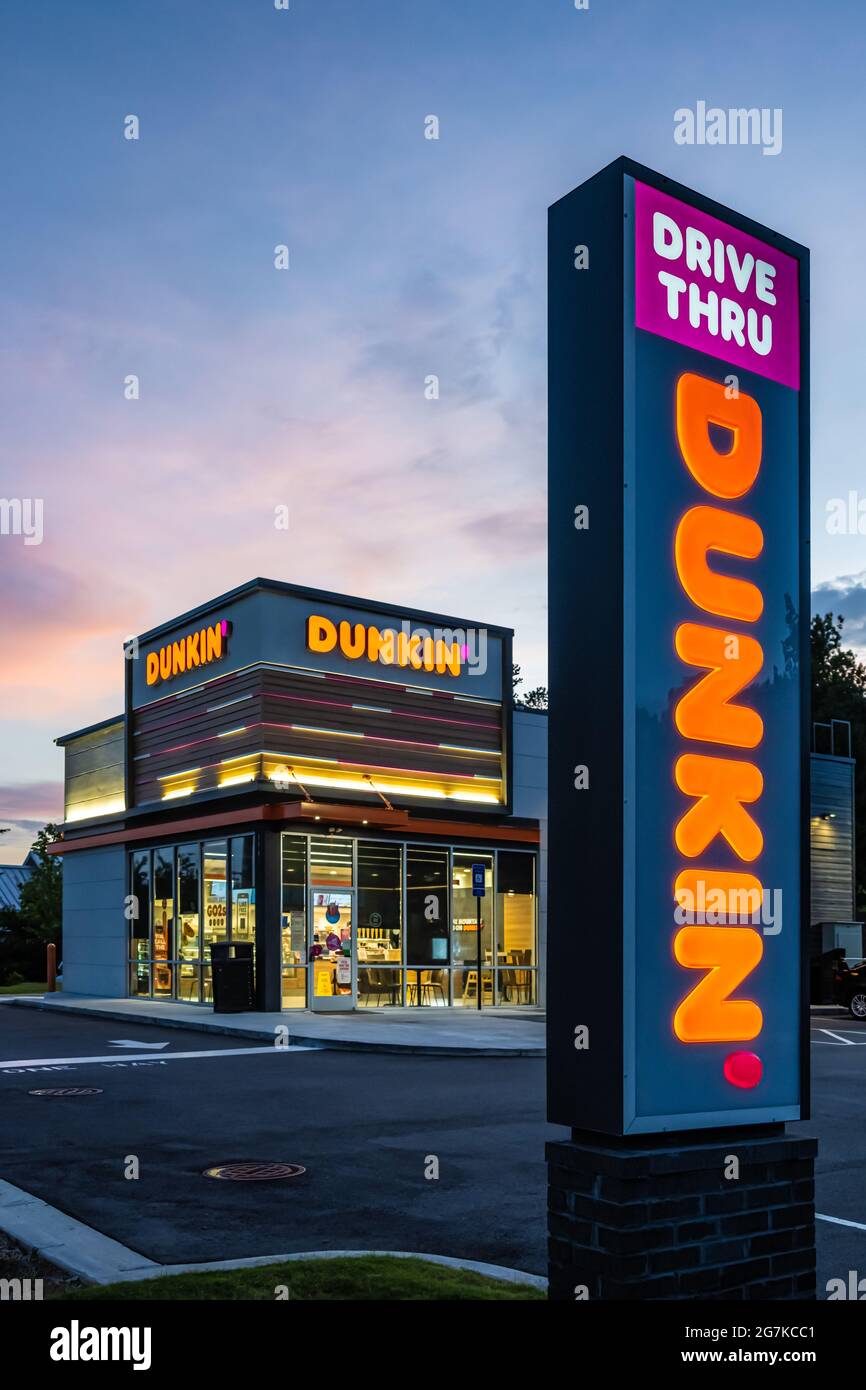 Dunkin' (formerly Dunkin' Donuts) coffee and donut shop at dusk in Snellville, Georgia, just east of Atlanta on Highway 78. (USA) Stock Photo