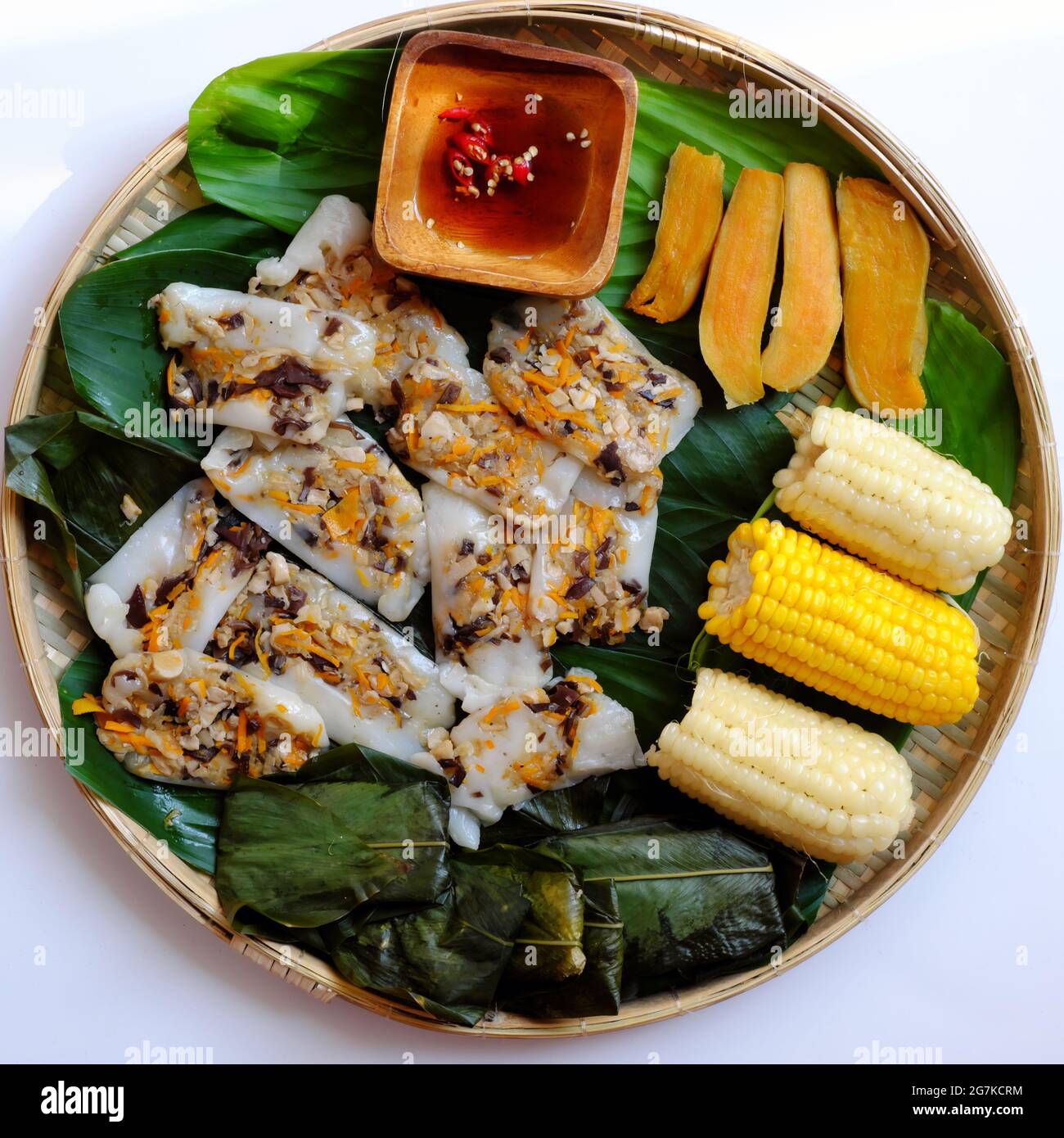 Top view simple tray of vegan food, rice flour leaf cake, boiled corn