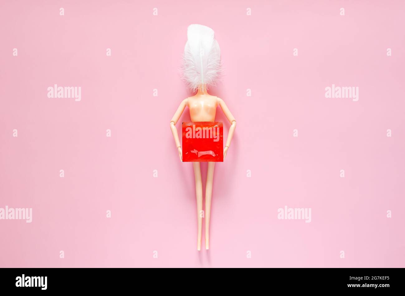 Naked doll holding condom package for minimal safe sex, world sexual health  and aids day concept Stock Photo - Alamy