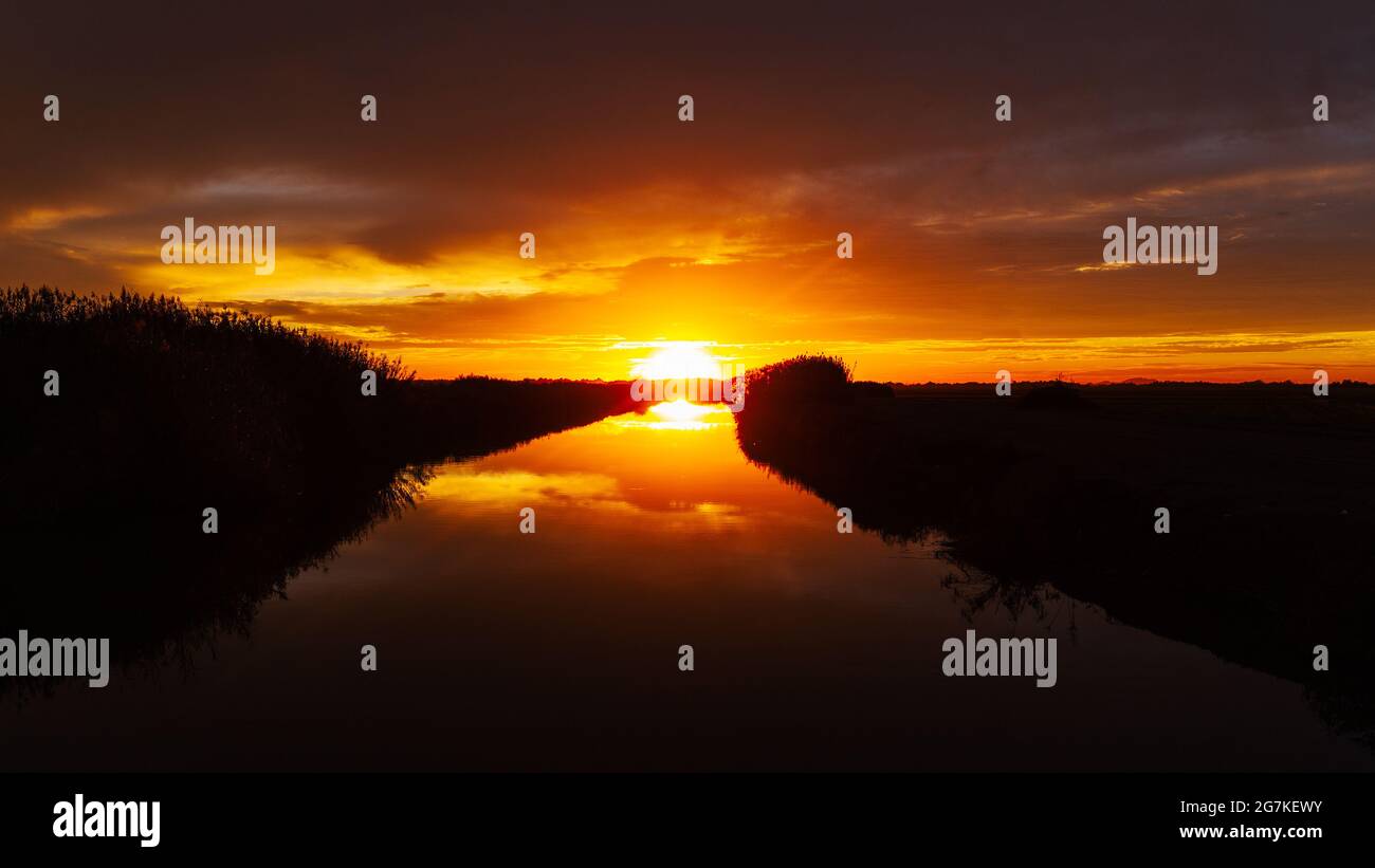 Sunset over a canal Stock Photo