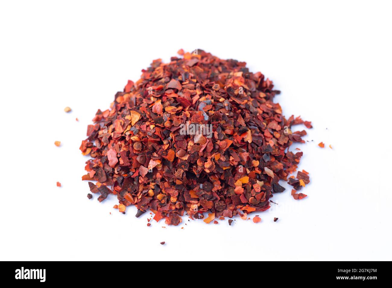 Pile of crushed red chilli pepper, dried cayenne pepper flakes isolated on white background