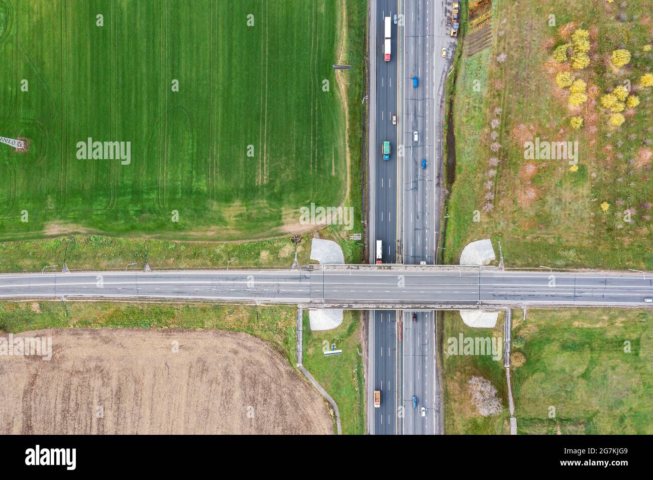 highway overpass between agricultural fields. road intersection with cars traffic. aerial view Stock Photo