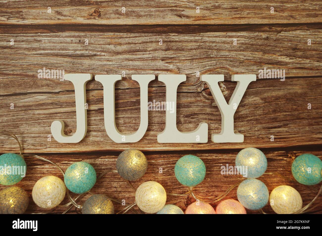 August alphabet letter with LED cotton balls on wooden background Stock ...